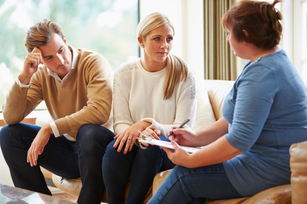 Couple in therapy session with counselor.