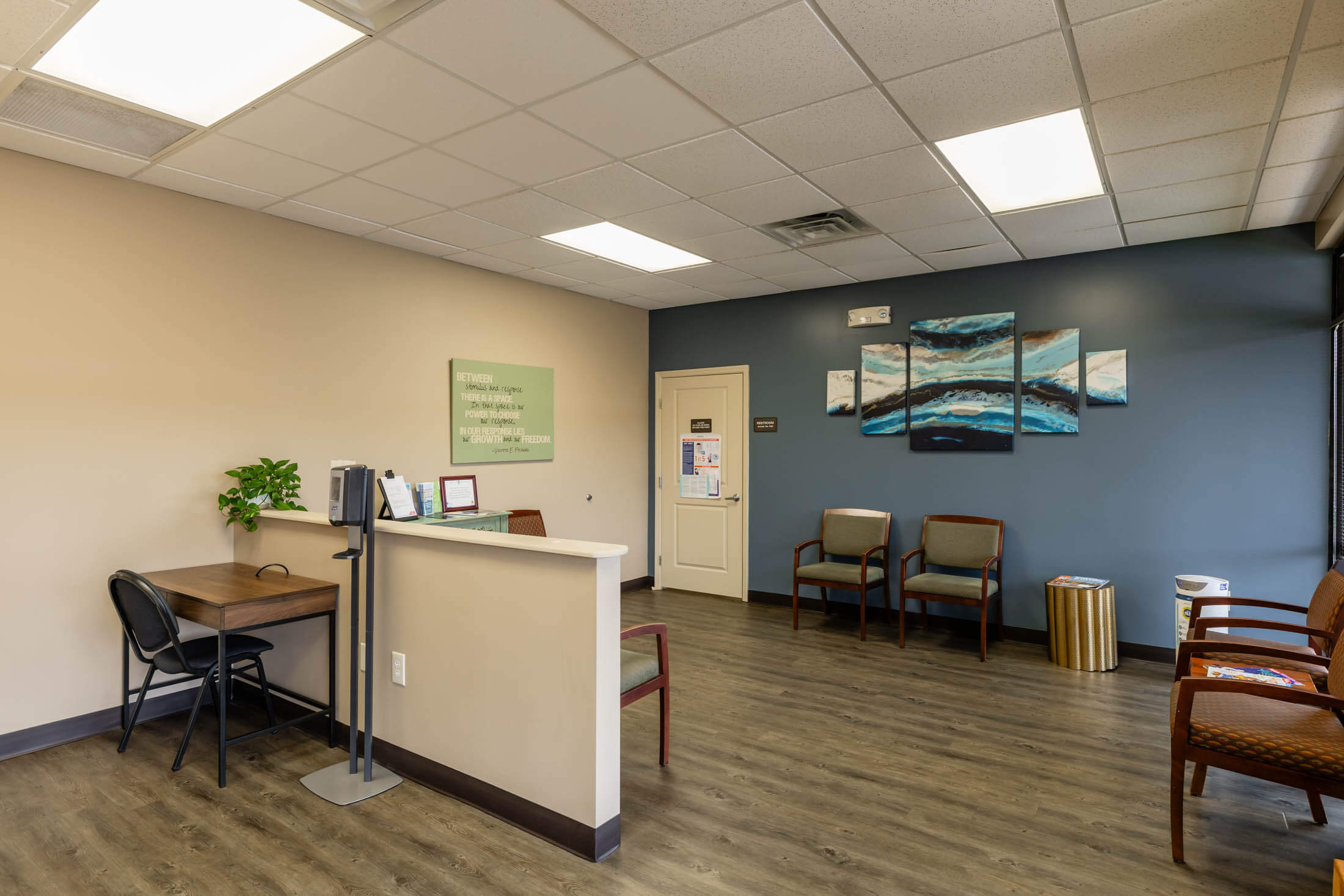 Waiting room with chairs and reception desk.