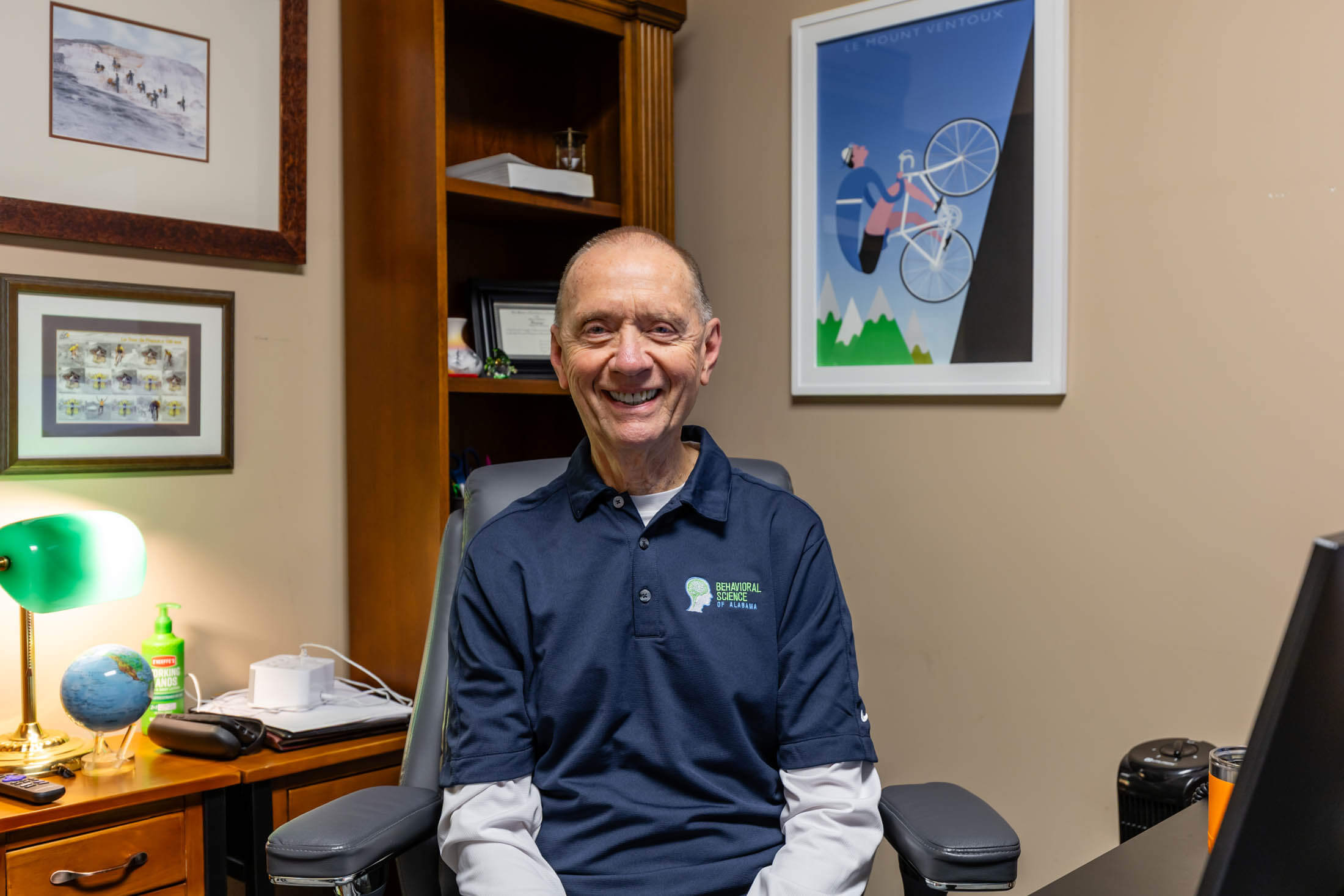 Smiling man seated in a home office.