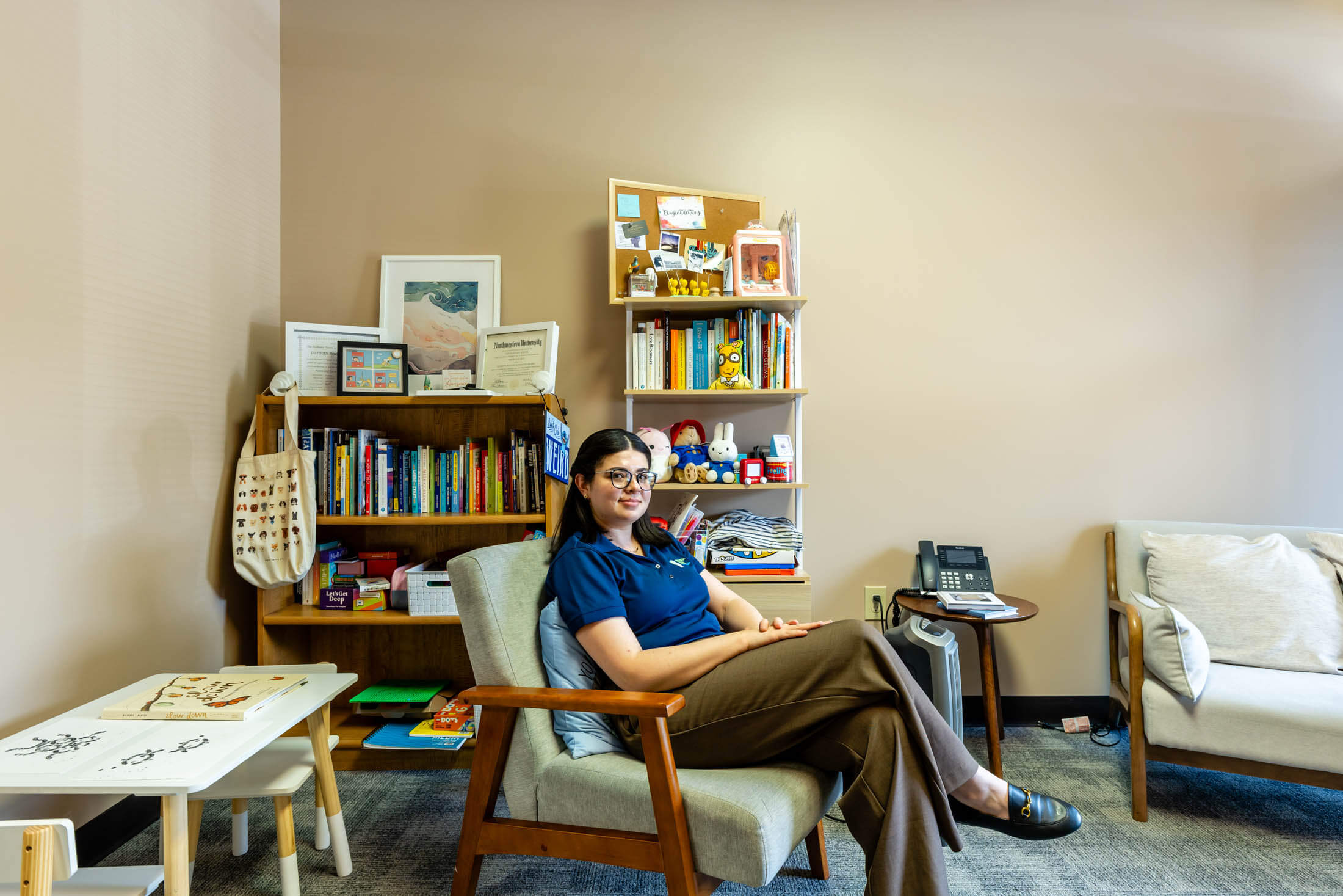 Person sitting in a cozy office space.